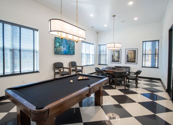 a games room with a pool table and a table and chairs