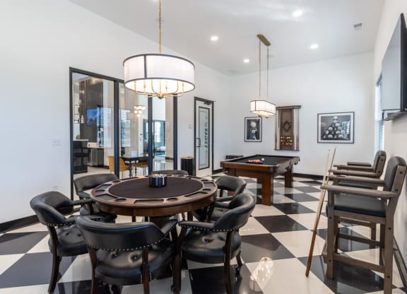 a dining room with a table and chairs and a pool table