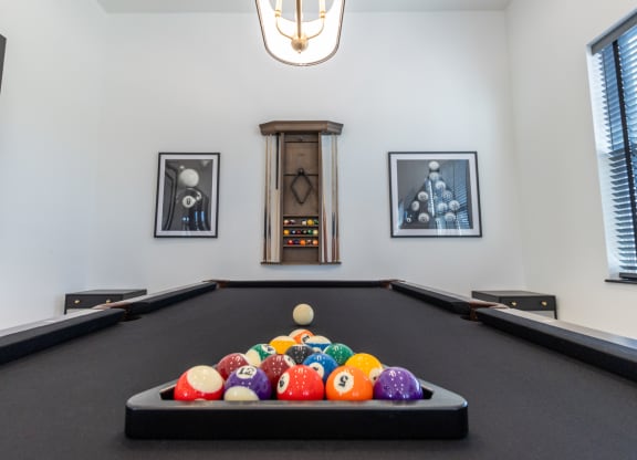 a billiards table with a bunch of balls on it