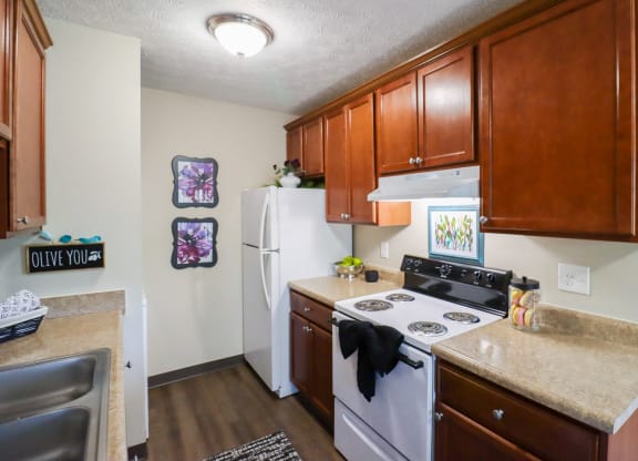 A kitchen with a white refrigerator and a white stove.
