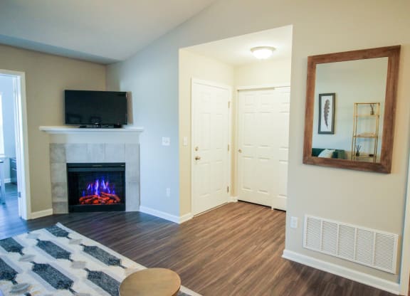 a living room with a fireplace and a television