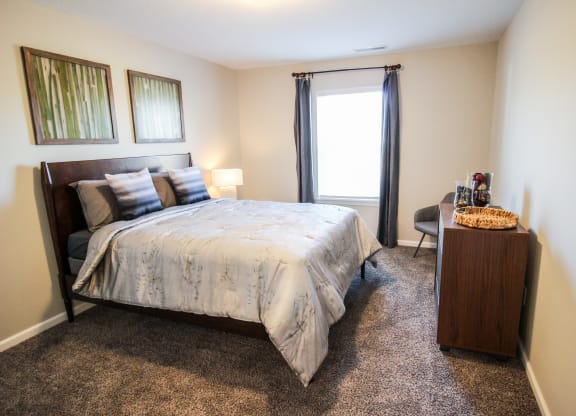 a bedroom with a bed and a desk