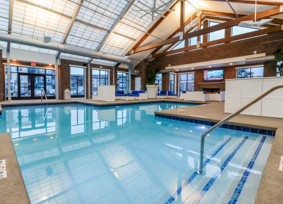 a large indoor swimming pool with a glass ceiling
