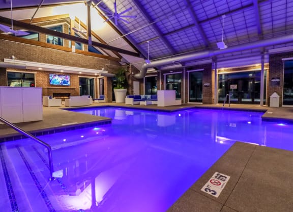 a large indoor pool with a ceiling with skylights
