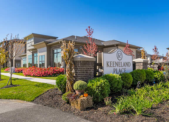 A Keeneland Place sign is displayed in front of a building.