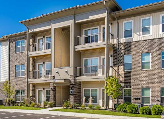 Apartment building with a clear blue sky above.