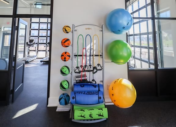 a white wall with a bunch of balloons and a trolley