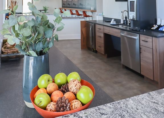 a bowl of fruit on a table in a kitchen