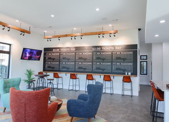 a lobby with chairs and a large board on the wall