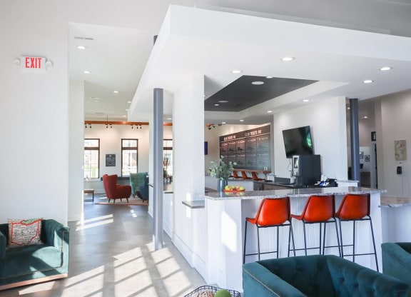 a living room with a bar and a kitchen