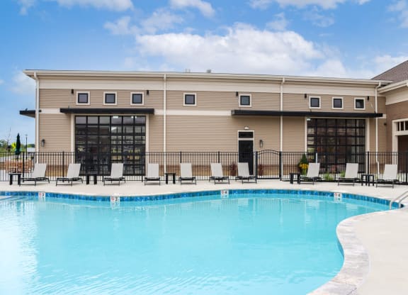 a swimming pool in front of a resort building