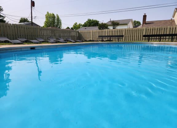 a large swimming pool with a fence around it