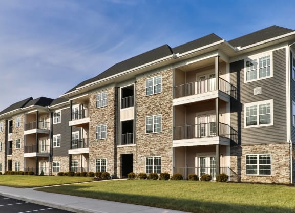 an exterior view of an apartment building on a sunny day