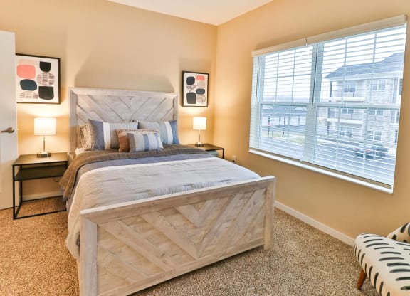 a bedroom with a bed and a window