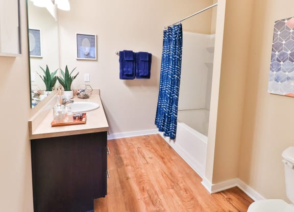 a bathroom with a shower and a sink and a toilet