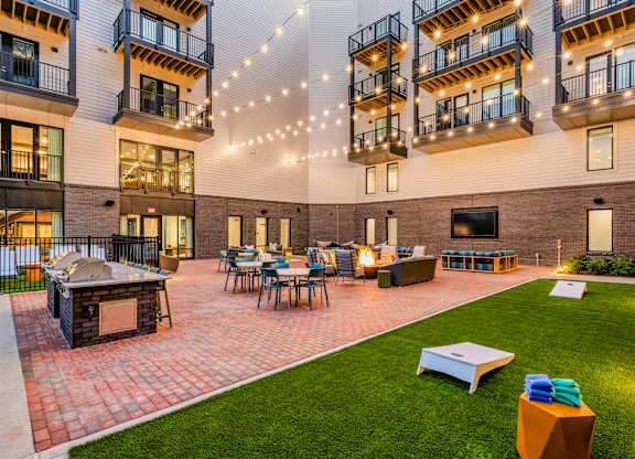 A patio area with a fireplace and seating area.