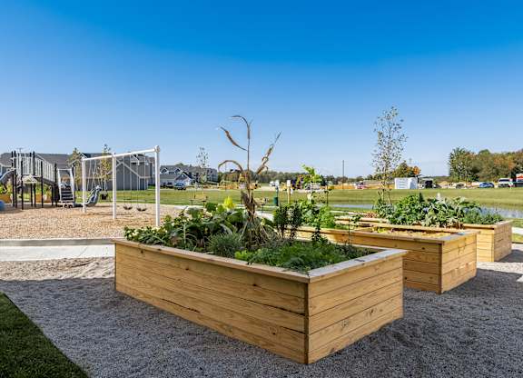 A playground with a swing set and a play area with a slide.