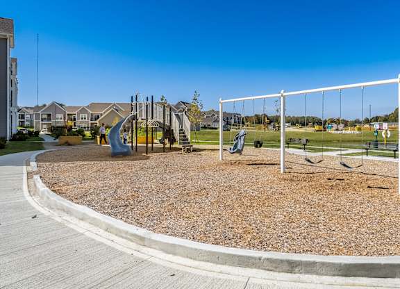 A playground with a swing set and a slide.