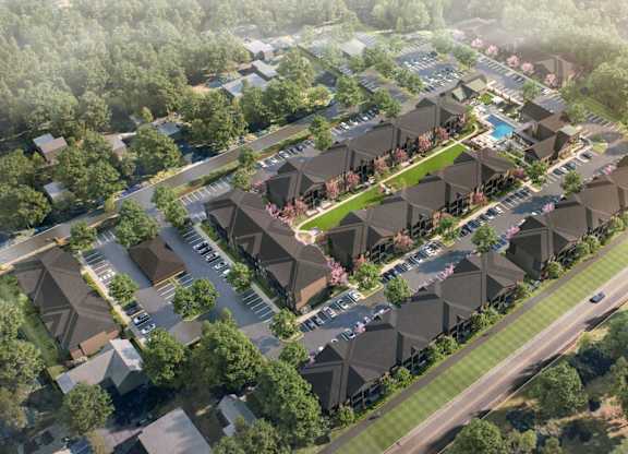 A bird's eye view of a residential area with houses and greenery.