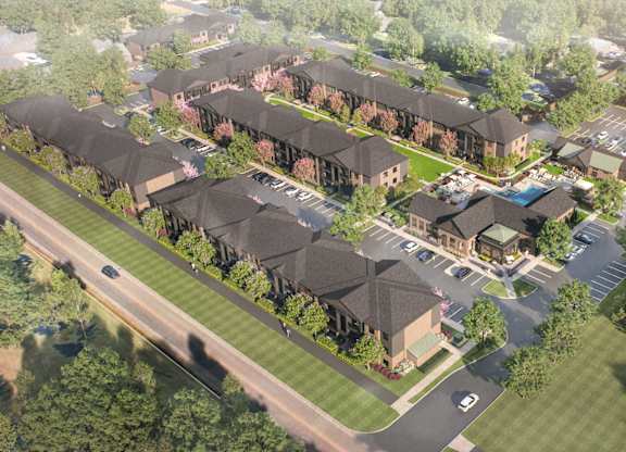 A bird's eye view of a residential area with houses and a parking lot.