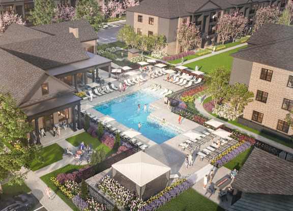 A large outdoor swimming pool surrounded by lounge chairs and umbrellas.