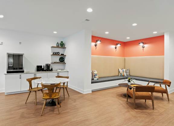 A kitchen with a dining table and chairs.