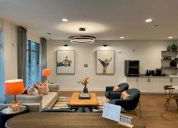 A living room with a sofa, armchairs, and a coffee table.