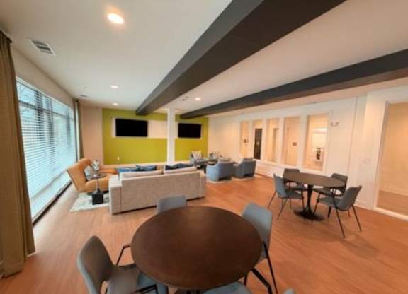 A modern living room with a brown table and chairs.