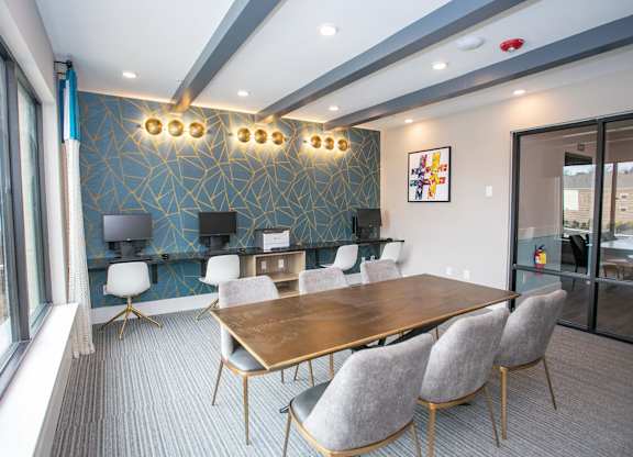 A conference room with a long table and chairs.