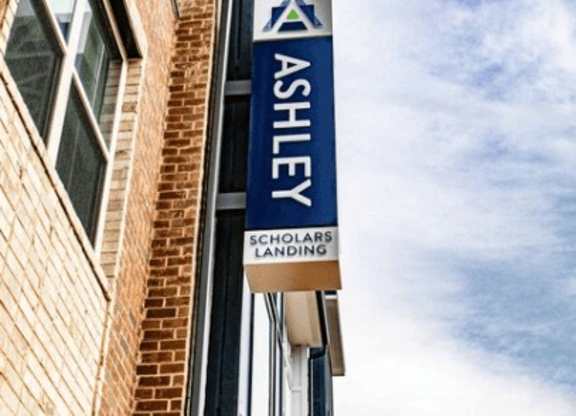 A sign for Ashley Solar Landing is displayed on a building.