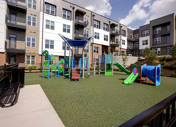 A playground with a slide, swings, and a climbing frame.