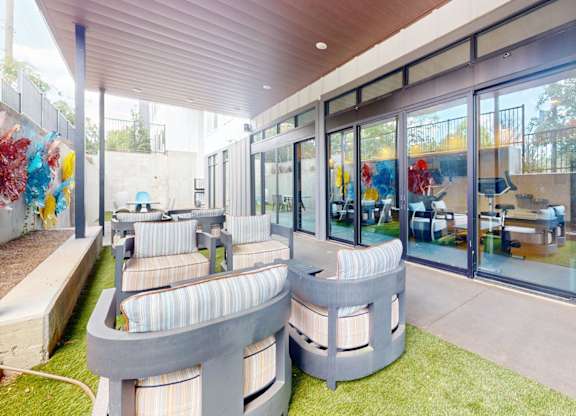 A modern outdoor seating area with a curved bench and a table.
