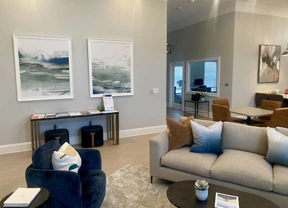 A living room with a blue chair and a beige couch.