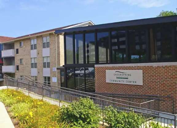 A building with a sign that says Greenspring Community Center.