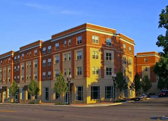 A large red brick building with a yellow trim.