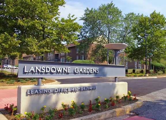 A sign for Lansdowne Gardens with a leasing office phone number.