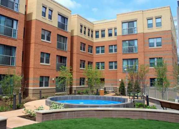 A large building with a pool in the front yard.