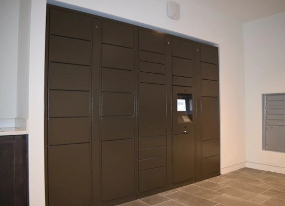 A brown door with a small window in the middle.