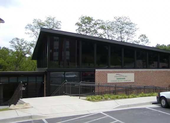 A building with a sign that says Greenpeace Community Center.