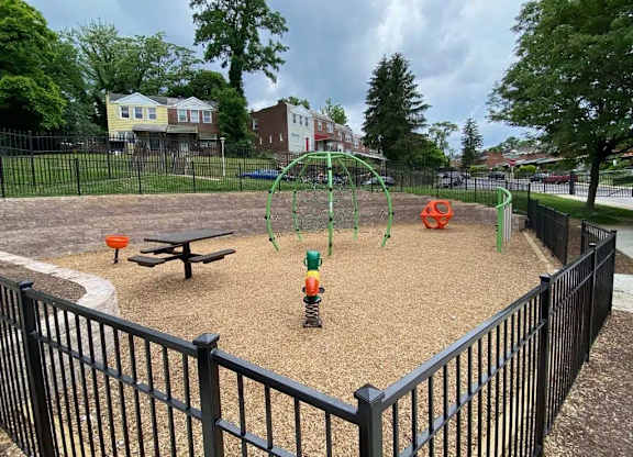 A playground with a swing set and a sandbox.