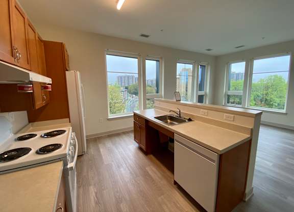 an empty kitchen with a stove and a sink
