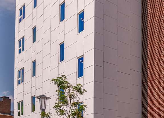 a white building with blue windows on the side of it