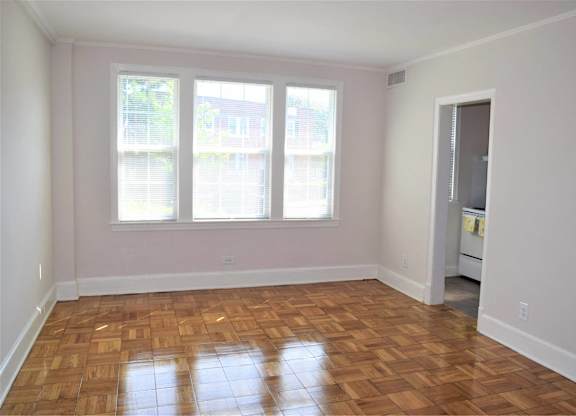 A room with wooden floors and a white door.
