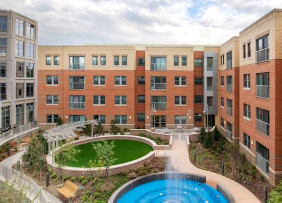A large building with a pool in the middle of a courtyard.