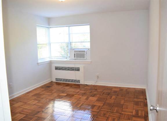 A room with a window and a fan.