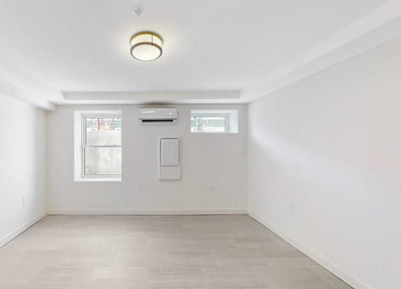 A white room with a window and a door.