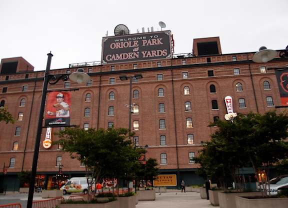 A large brick building with a sign that says Oriole Park at Camden Yards.