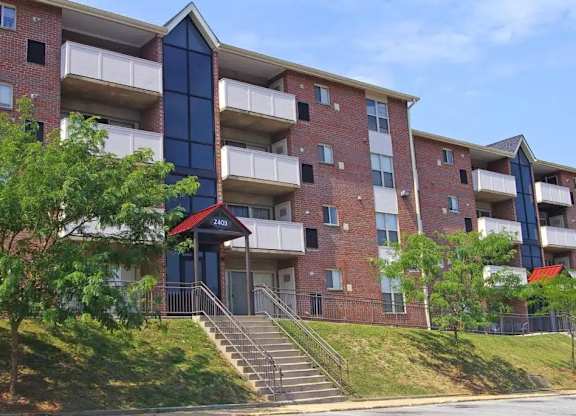A red brick apartment building with a blue accent on the front.