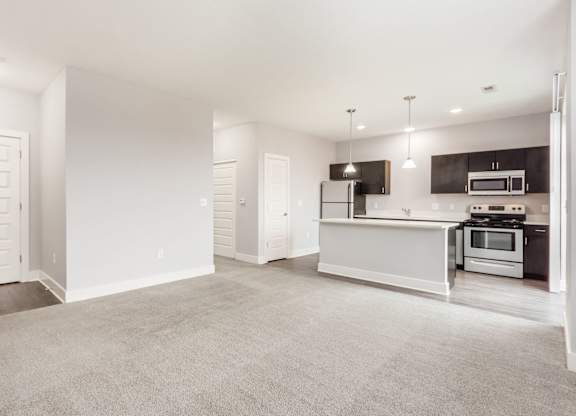 A spacious kitchen with a white countertop and modern appliances.