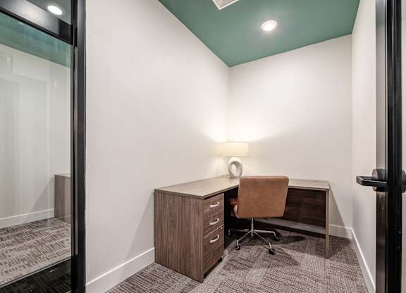 A room with a desk and a chair.